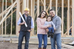 A family with a young child is excited about building their new home