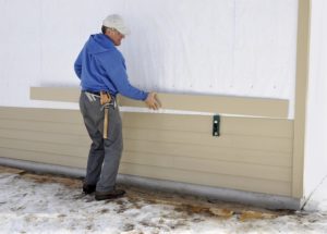 A man replaces home siding