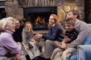 A multi-generational family sits in their living room